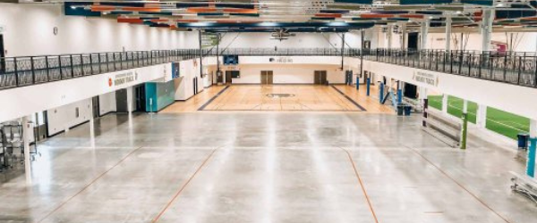 picture of a concrete surface with a school gym in the background