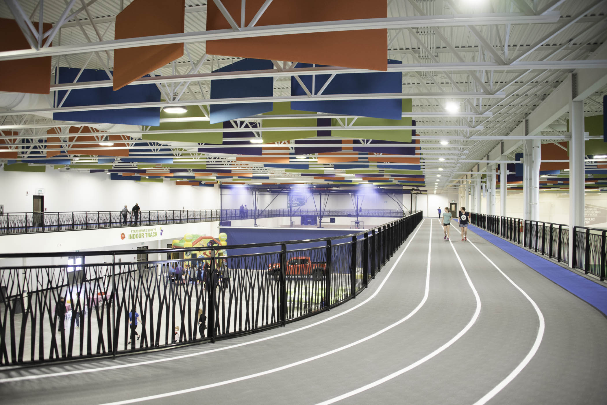 A picture of an indoor walking track with several lanes