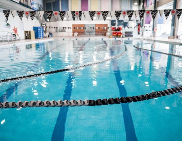 picture of a swimming pool with lane divider ropes.